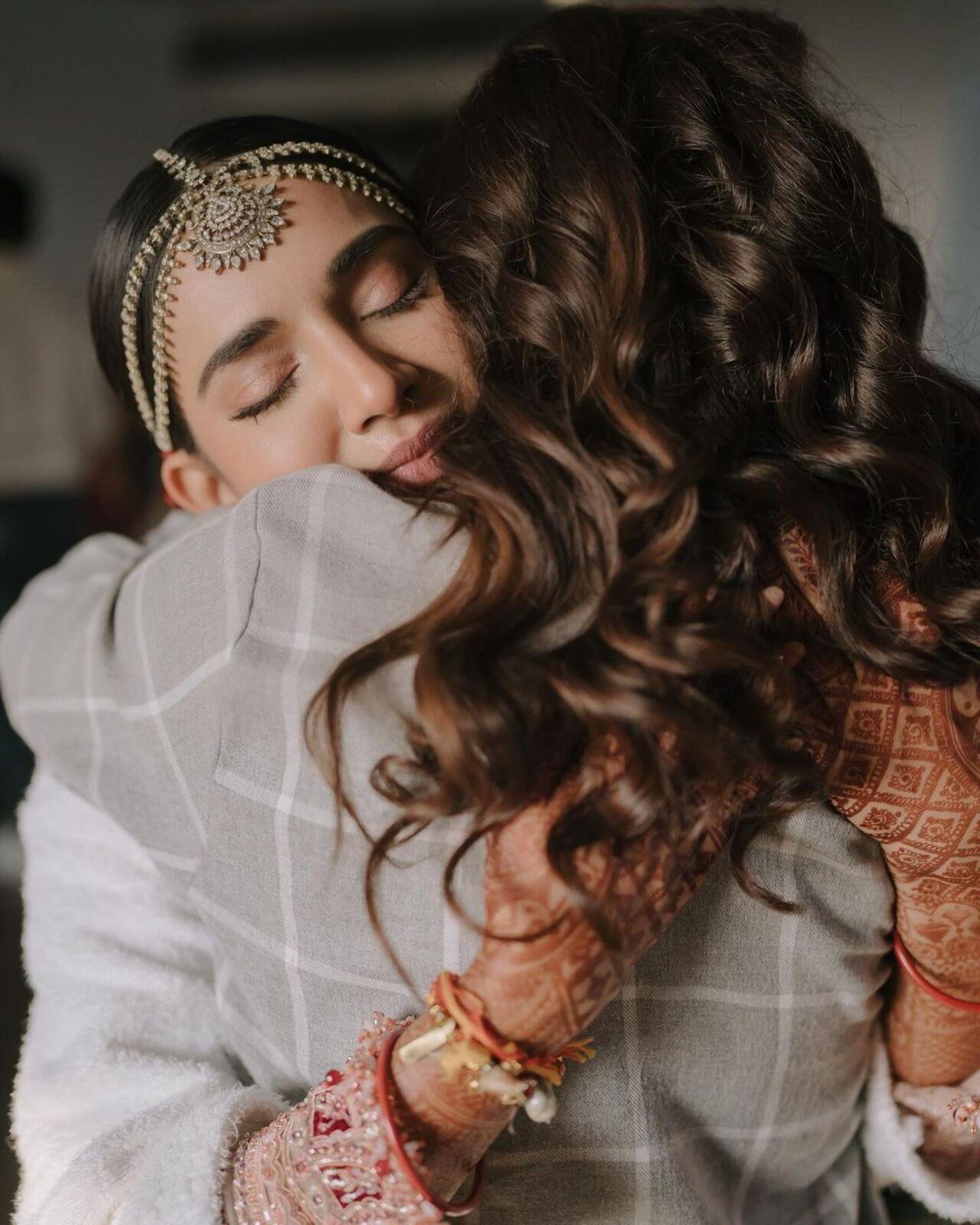 This photo shows the bride getting emotional as she hugs her sister