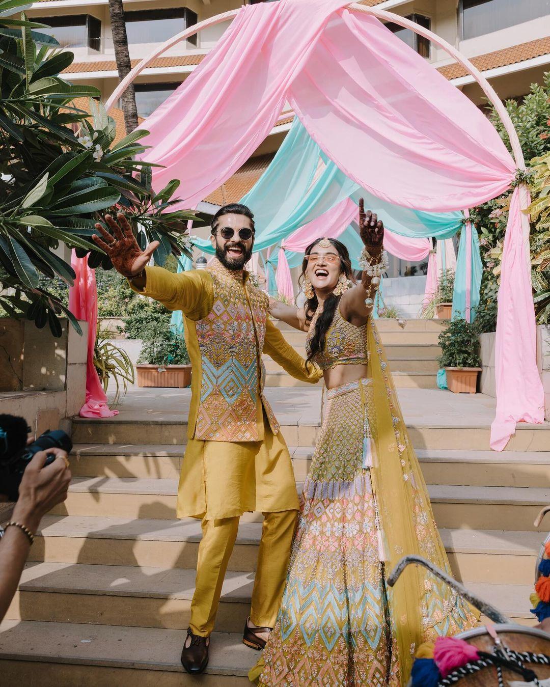 For the mehendi ceremony, Mukti opted for a multicoloured pastel lehenga with a heavily embroidered yellow blouse and dupatta, while Kunal complemented her in a matching sherwani