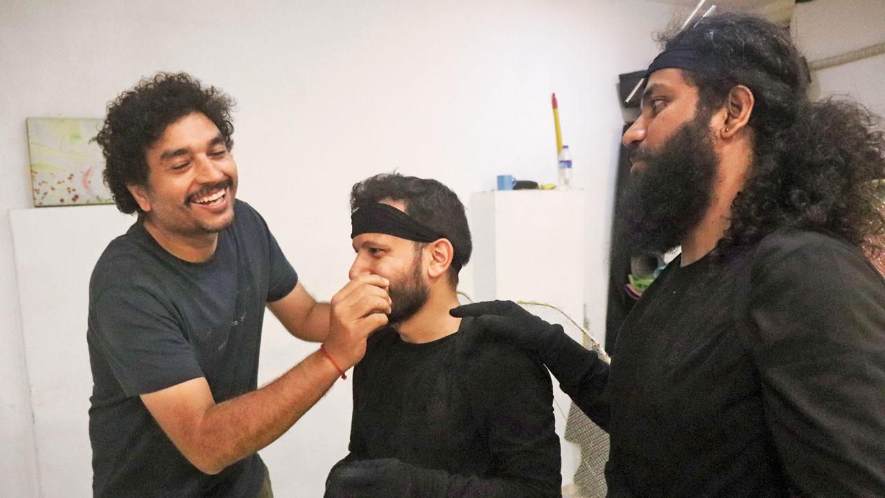 Nayyar (left) adjusts a cast member’s makeup