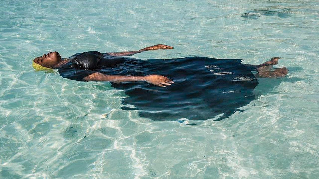  A young woman learns to float, in the Indian Ocean, off Nungwi, Zanzibar, in a picture that’s part of the exhibition. Pic/Anna Boyiazis
