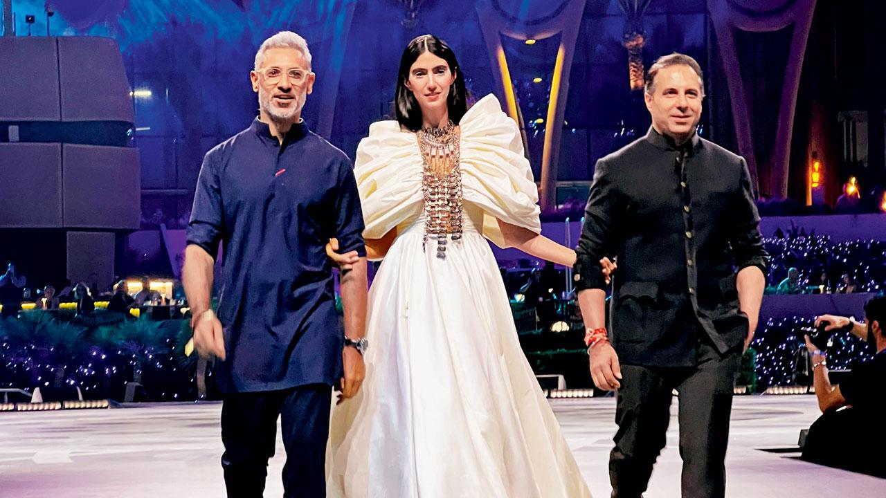(From left) A model walks in an outfit from the Indra collection; NIkhil and Shantanu Mehra walk the ramp