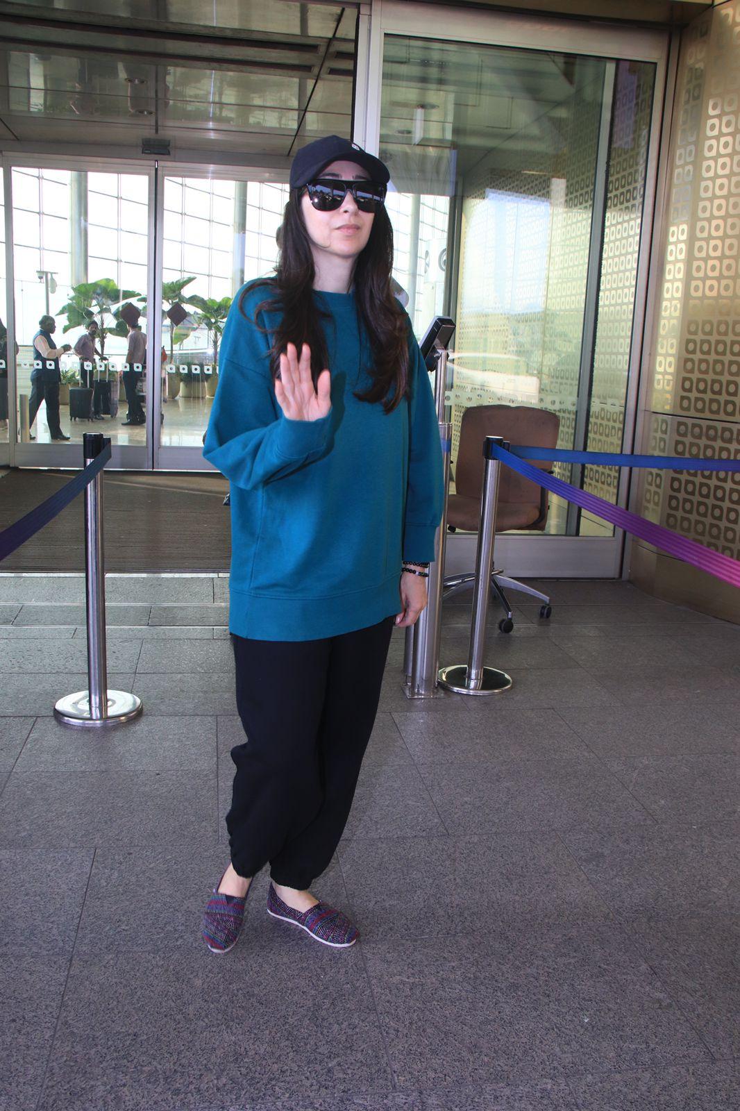 Karisma Kapoor looked uber cool in a plain blue hoodie paired with black jeans as she was clicked at the airport