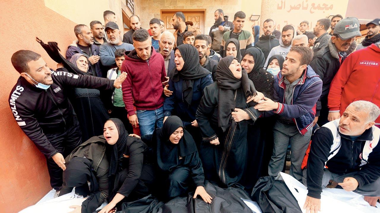 People mourn over the bodies of relatives at Nasser hospital. Pic/AP