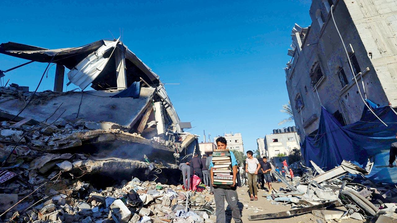 Palestinians recover items from rubble