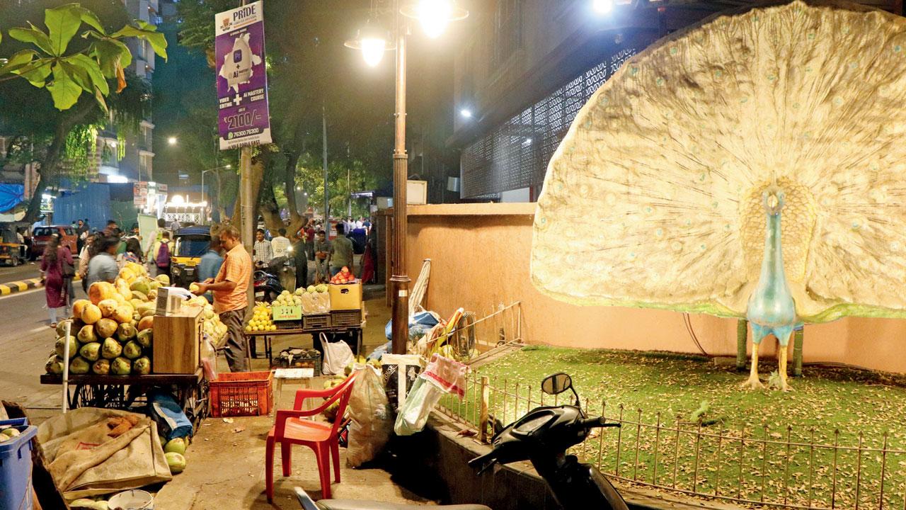 Hawkers occupy a footpath next to a beautification site on Nehru Road in Vile Parle East on Thursday. Pic/Anurag Ahire