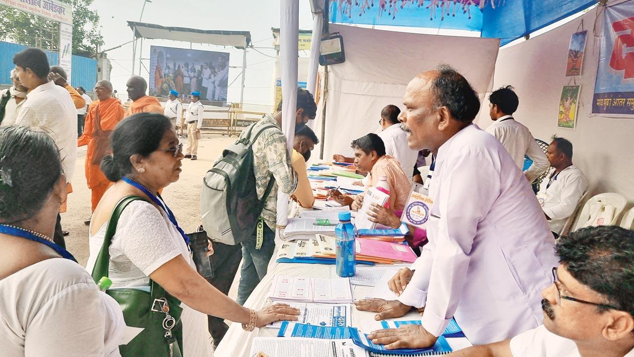 AA volunteer Jaipal interacts with pilgrims at the stall at Chaityabhoomi on Wednesday