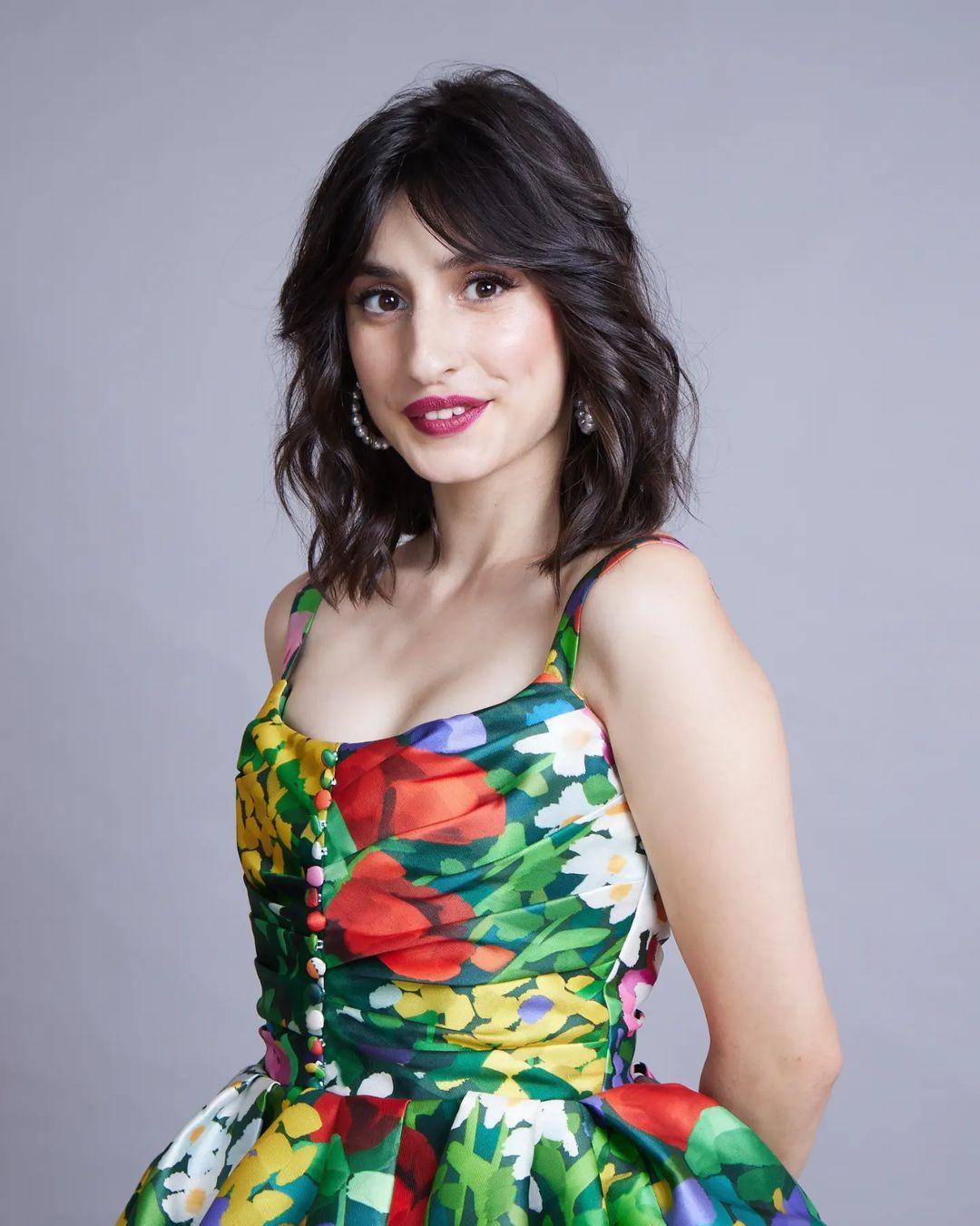 She paired the look with a signature red lip that complemented the floral motifs on the dress