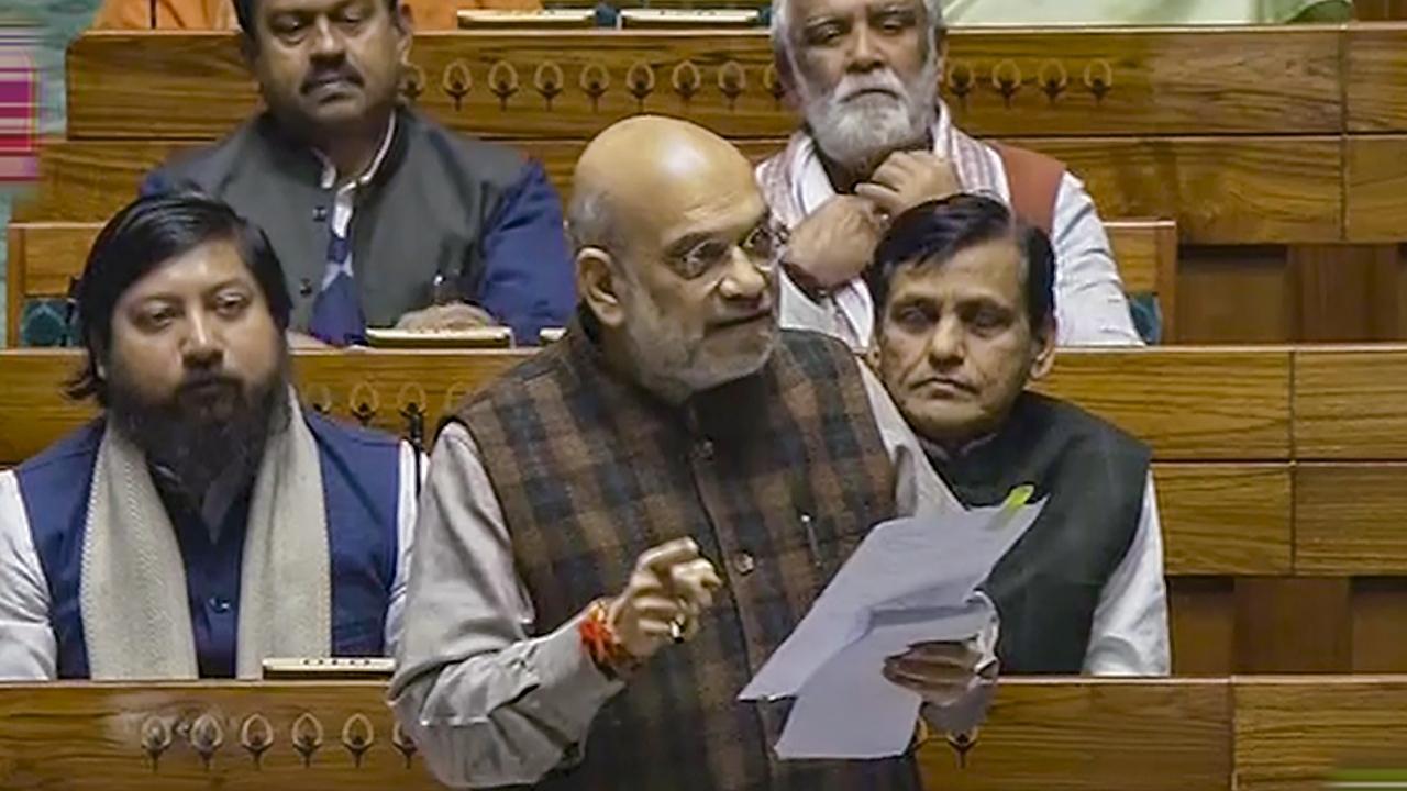 Union Home Minister Amit Shah speaks in the Lok Sabha during the Winter session of Parliament. Pics/PTI (Text/ANI)