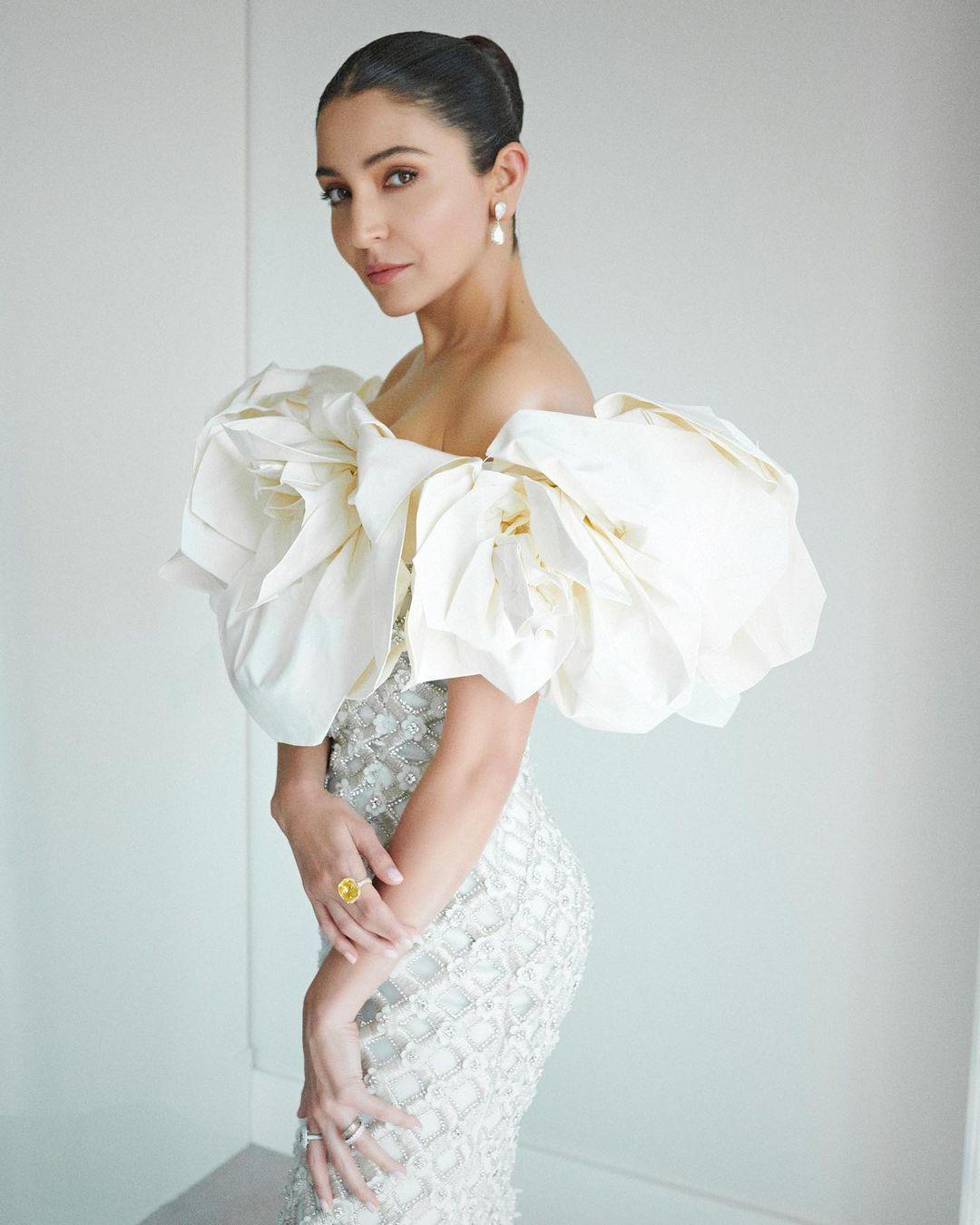 Anushka Sharma look ethereal as she marked her Cannes 2023 debut in a cream-coloured off-shoulder gown from Richard Quinn's fall/winter 2023 collection.
