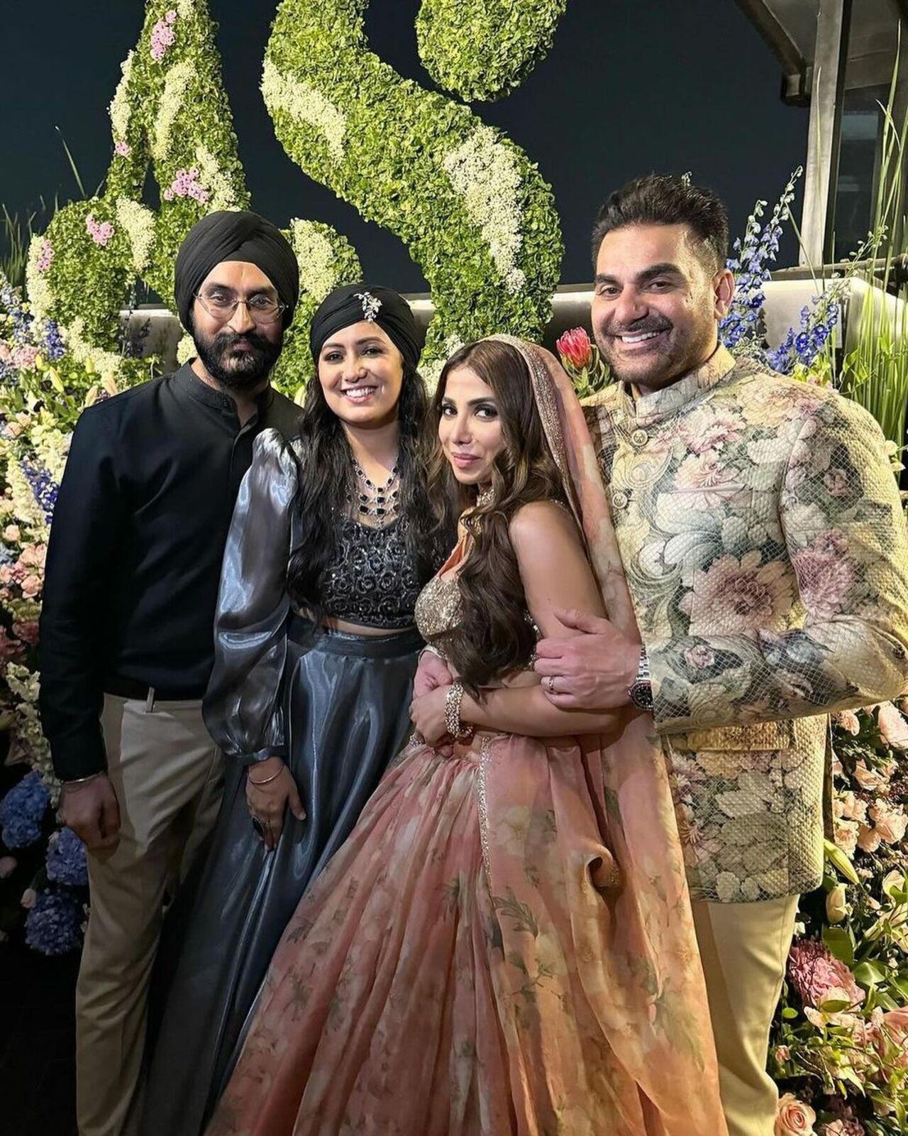 Newlyweds pose with guests at the wedding