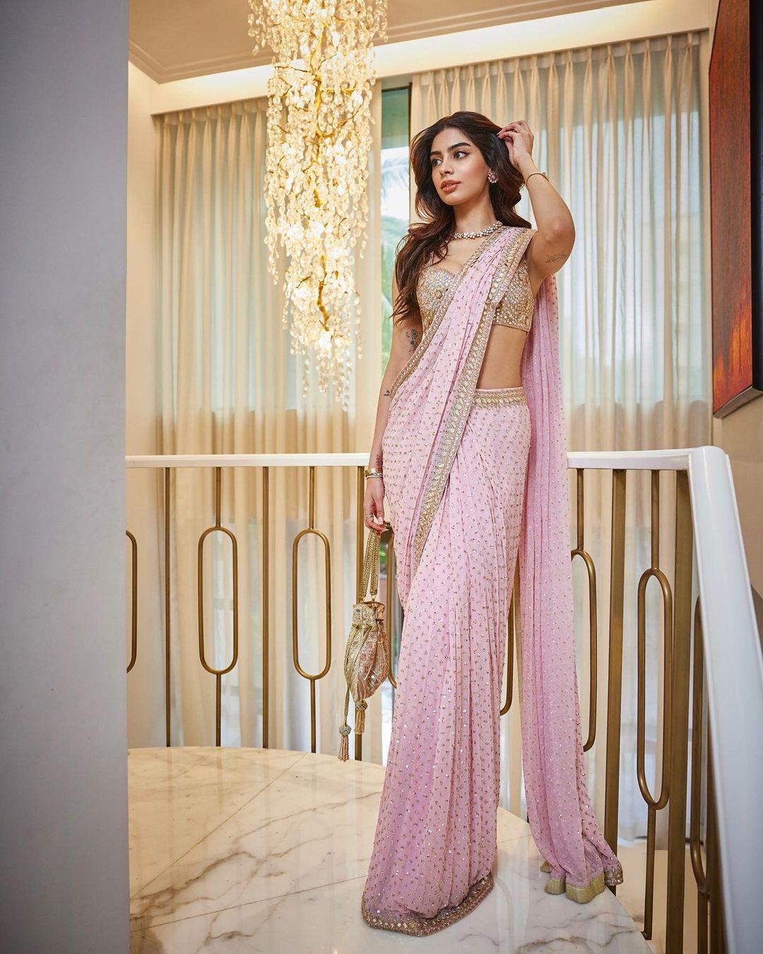 Khushi exudes regal vibes in a heavily embroidered pink saree. The combination of rich colours and traditional aesthetics showcases a perfect blend of classic elegance and modern charm