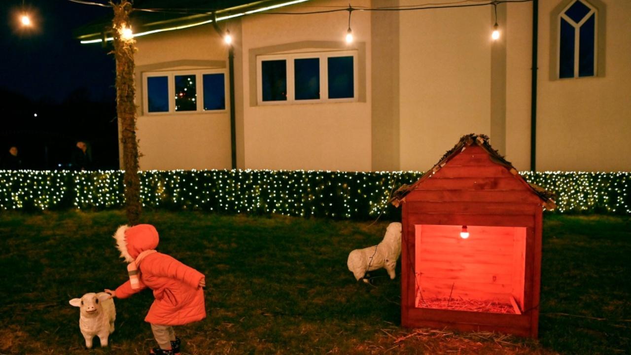 A little girl plays in the yard of the local Catholic church on the eve of the Christmas celebrations in the village of Petrushan, near the town of Gjakova. (Photo by Armend NIMANI/AFP)
