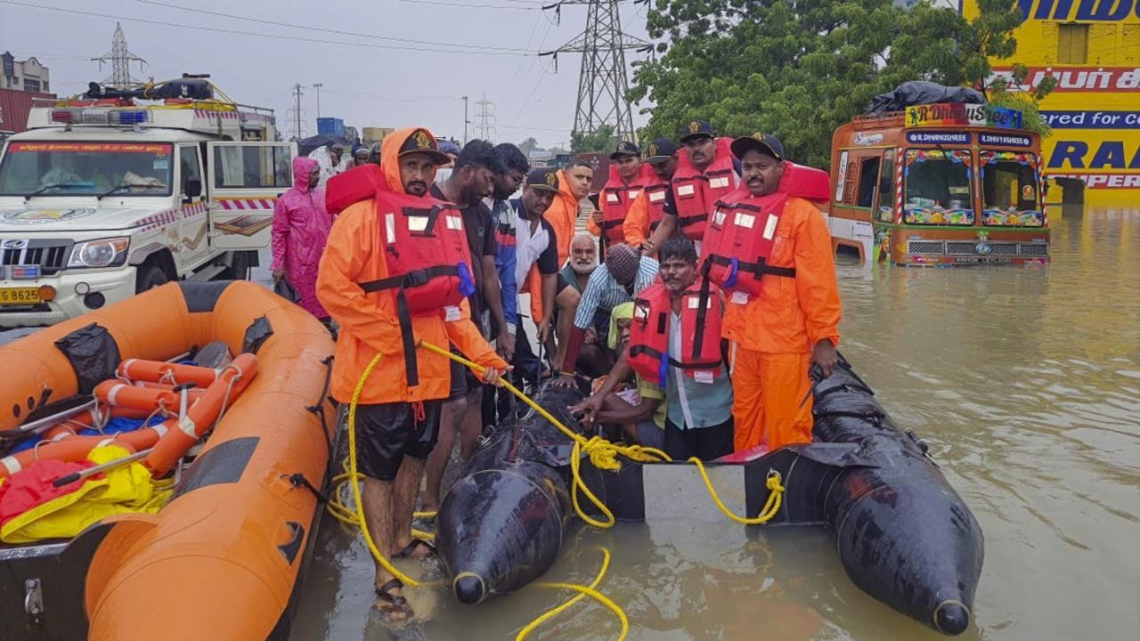 Indian Coast Guard men at rescue work in flood-hit Tuticorin district of Tamil Nadu. Pics/PTI