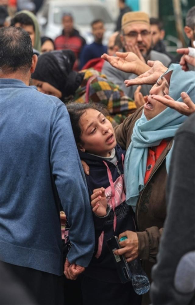 Palestinians mourn the death of loved ones following Israeli bombardment in the southern Gaza Strip on December 5, 2023, outside a hospital in Khan Yunis.