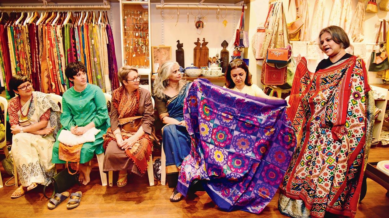 (From left) Nandini Sarkar-Shinde, Rose Marie Savio, Sarah Montague, Deepali Furtado, Aarti Mittal watch on as Savitha Suri shares a nugget on Gujarat’s double ikat patola at the Potluck of Nostalgia session. She is holding up Mittal’s mother’s Paan Bhat patola in traditional red and white. Pic/Shadab Khan