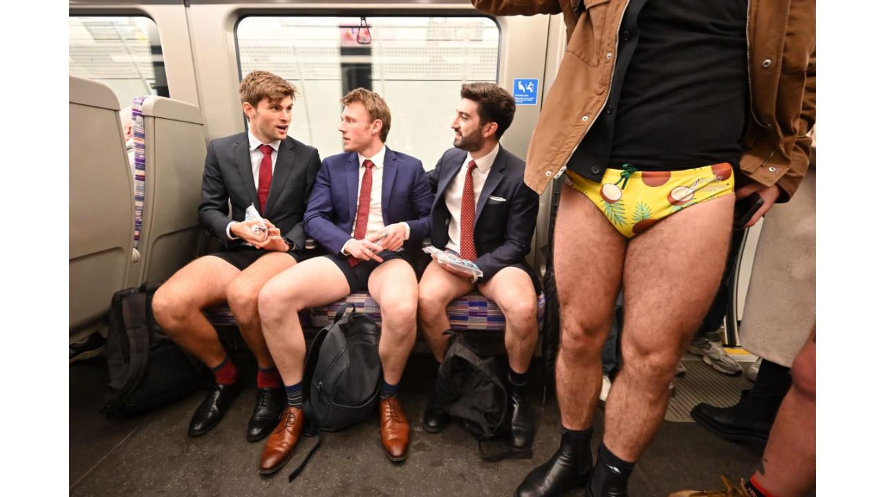 People take part in the annual 'No Trousers On The Tube Day' (No Pants Subway Ride) on the London Underground in central London on January 8, 2023. 2023 sees the 12th annual No Trousers Tube Ride in London. The day is now marked in over 60 cities around the world. The idea behind 