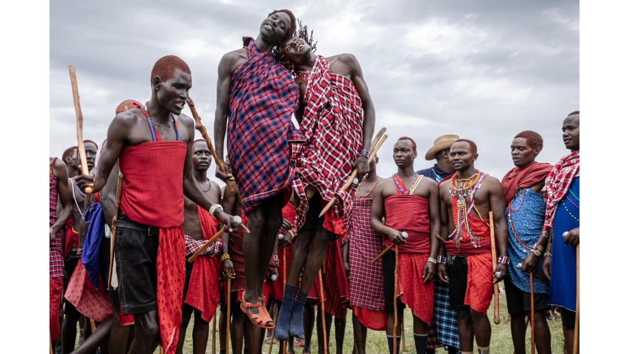 Young Maasai men perform their traditional jumping dance as they gather to sing and dance during the Eunoto ceremony in a remote area near Kilgoris, Kenya on August 18, 2023. Hundreds of young Maasai take part in the Eunoto ceremony, a rite of passage that marks the transition from Moran (young warrior) to adulthood as junior elders. This ceremony is held by every clan once in a generation -every 8 to 10 years- and marks a new age-set. Eunoto, Enkipataa and Olng'esherr are the three main Maasai rites of passage that have been inscribed since 2018 on the Urgent Safeguardiang List of Intangible Cultural Heritage by UNESCO. (Photo by Luis Tato/AFP)