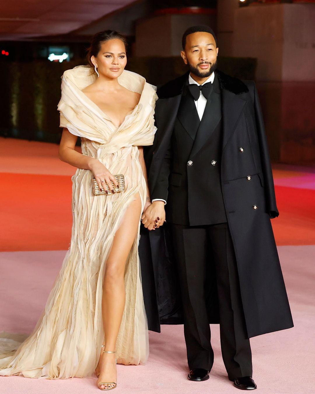 Chrissy Teigen wore a textured cream gown by Tony Ward. She posed with husband John Legend