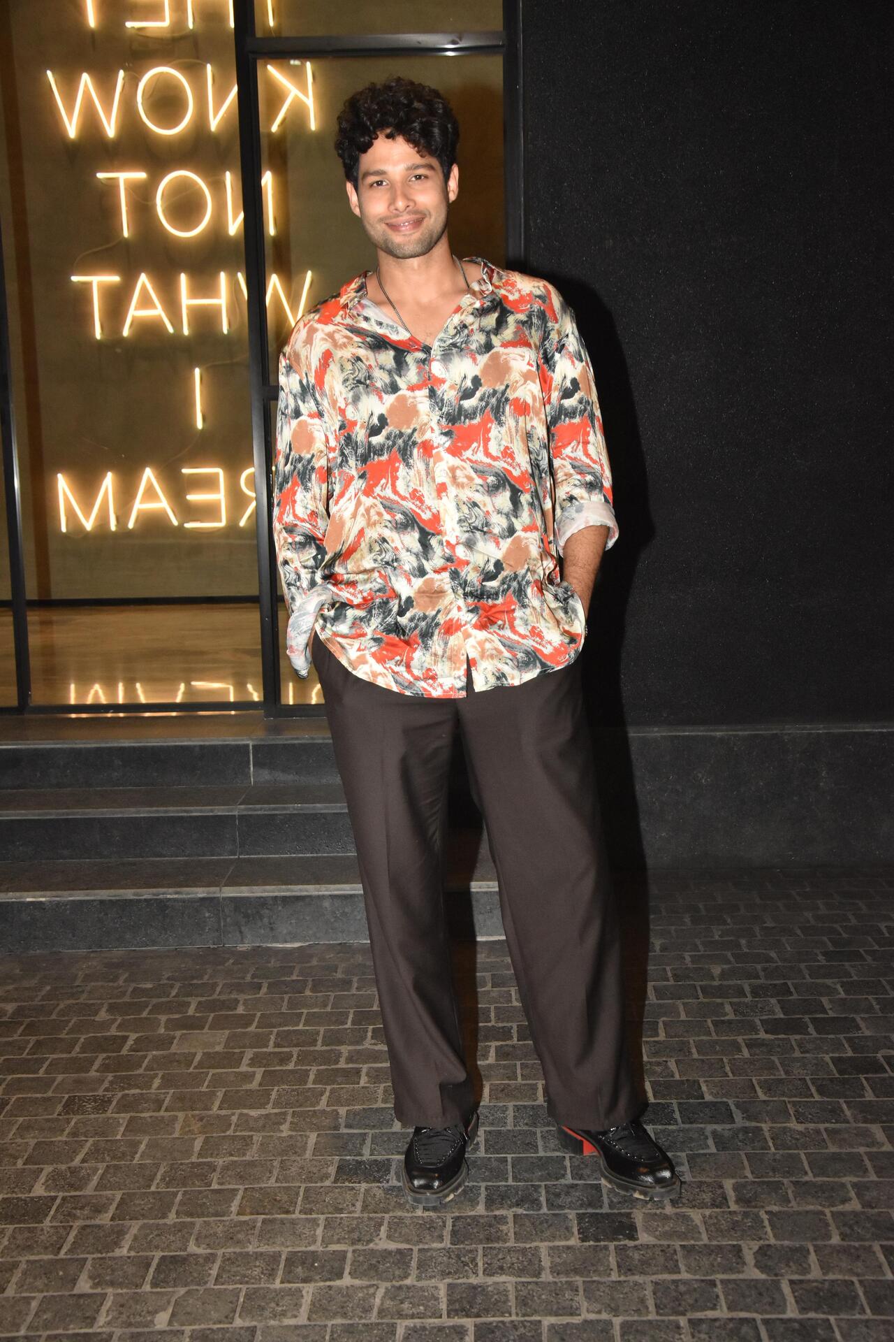 Siddhant Chaturvedi arrived in a floral-printed colourful shirt and brown pants for the screening