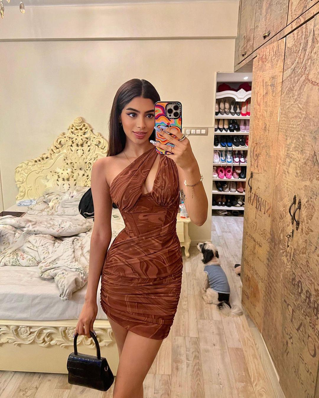 Khushi rocked a bodycon dress adorned with a stunning brown pattern—a soft power mesh dress featuring a captivating chocolate swirl design. The dress boasts an asymmetrical style, gracefully sweeping across one shoulder and sporting a chest slit that hints at a touch of cleavage. It's the perfect mix between bold and class - making it perfect for Christmas!