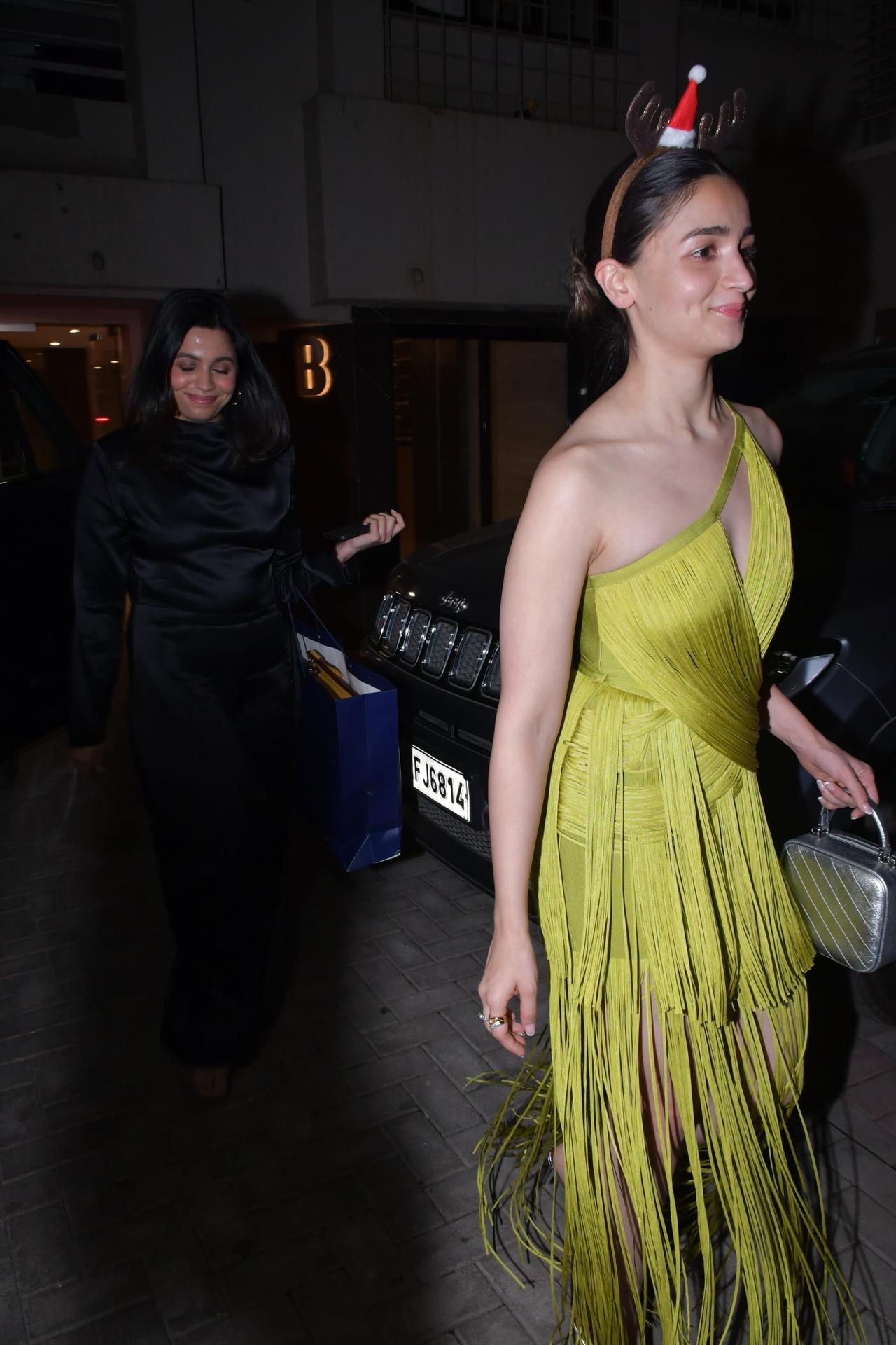 Bhatt sisters Shaheen and Alia step out together for dinner party at their father's house. While Shaheen looked stunning in a black dress, Alia went for a neon green dress