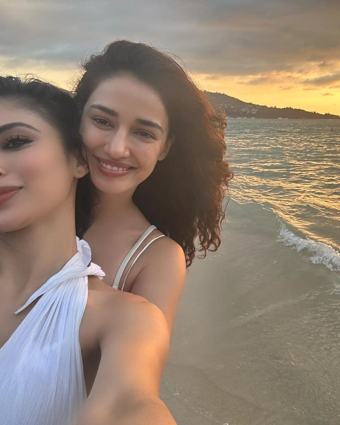 Disha and Mouni look so happy posing for a selfie here together as we see the sea in the background