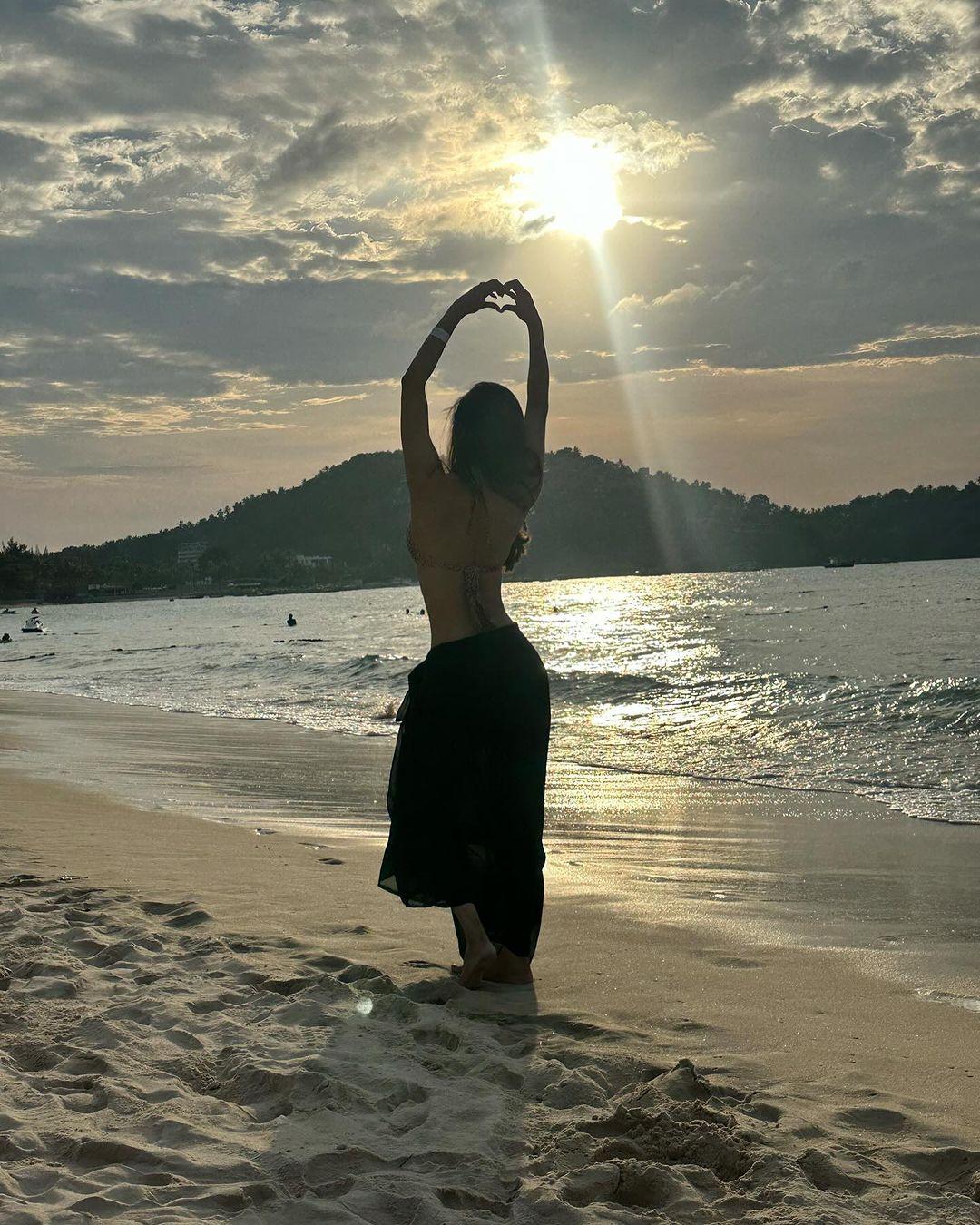 Mouni Roy shared this photo of her posing by the beach, making a heart with her hands. Her silhouette looks stunning against the sun