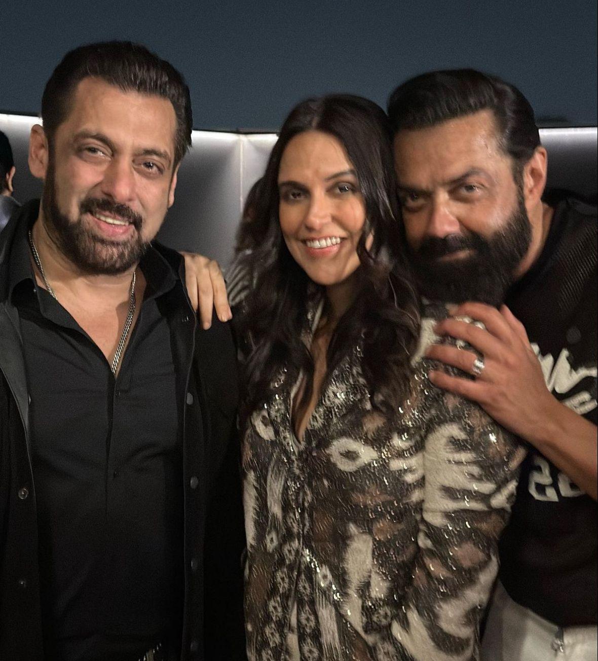 In this picture see Salman Khan flashing his smile while striking a pose with Neha Dhupia and Bobby Deol
