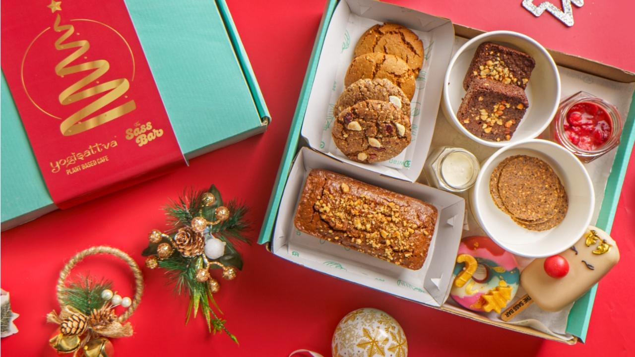 Festive Christmas Box Unveiling the enchanting Festive Christmas Box, a curated treasure trove that encapsulates the spirit of the season. The Orange, Cranberry & Walnut Loaf, presents a melody of flavours embodied in a 220gms delight, a mix of citrusy brightness, tart cranberries and the satisfying crunch of walnuts. Accompanying this sweet indulgence are the Ginger Molasses Cookies and White Chocolate Cranberry Cookies, each a testament to the art of holiday baking. 
Where: Yogisattva, KharPrice: Rs 2499 onwardsLog onto: yogisattva.com 