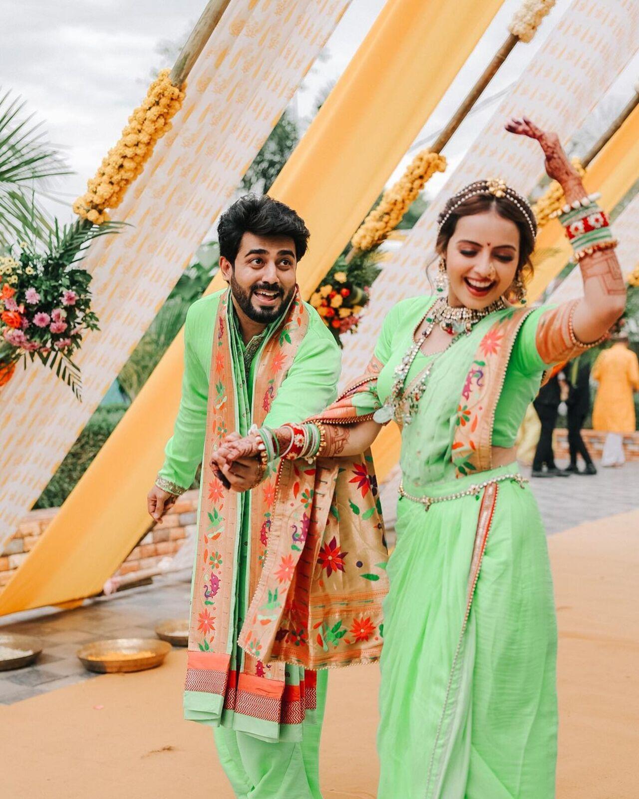 The actress is wearing a beautiful green outfit in the images. She adorned a parrot-green lehenga with an embroidered blouse, and the ruffled sleeves elevated the look