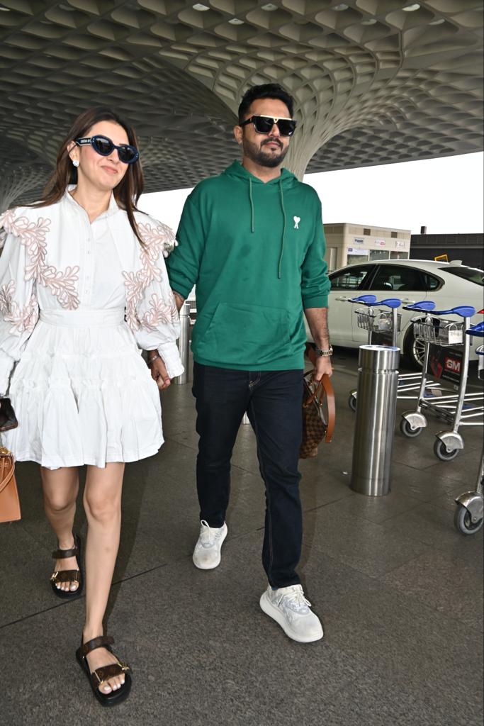 Hansika Motwani walks hand in hand with her husband as the two were clicked at the airport