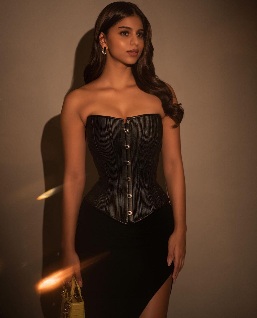 Suhana Khan looked stunning in a black strapless textured corset paired with a form-fitting black skirt featuring a high side slit. Despite her trendy style, she embraced classic elements.