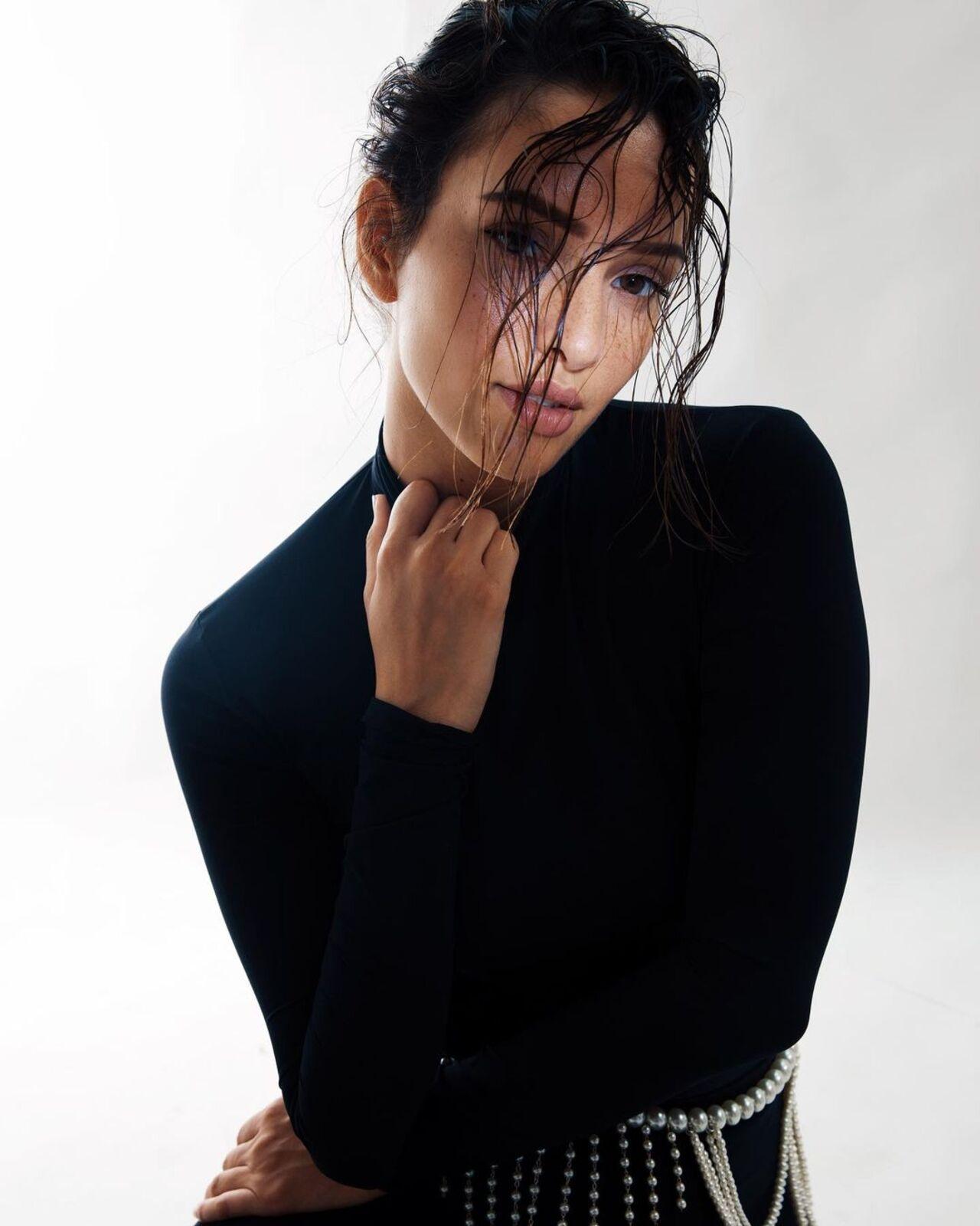 Triptii wears an all-black bodycon outfit with messy hair and subtle make-up
