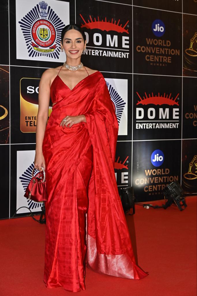 Manushi Chhillar opted for a stunning red saree as she was clicked at the event