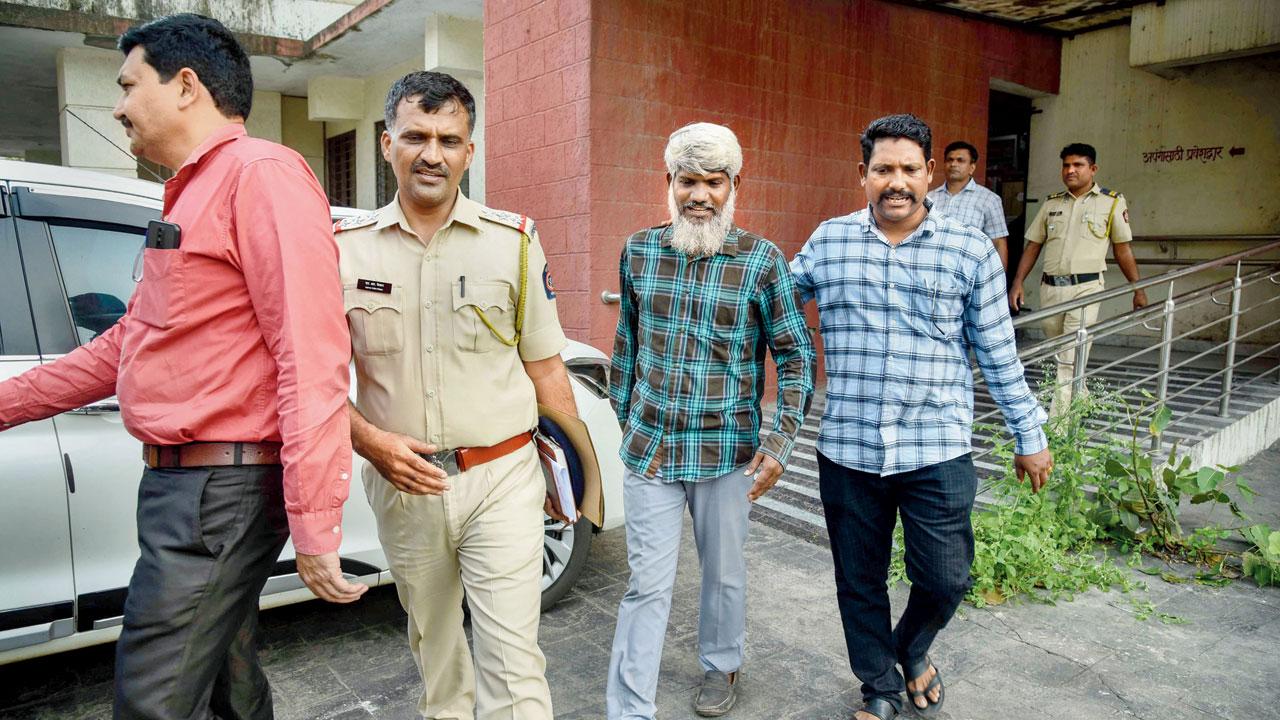 An arrested member of PFI being taken into custody after being produced before CBD Belapur Court in Navi Mumbai in 2022. File pic