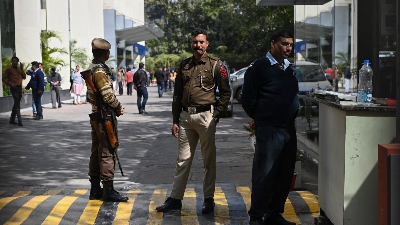 A police officer stands at the entrance of the office building where Indian tax authorities raided BBC's office in New Delhi. Pic/AFP
