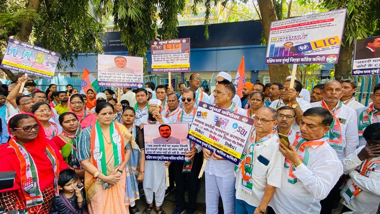 The supporters and workers of Congress party held placards and posters against Adani outside the SBI building in Mumbai