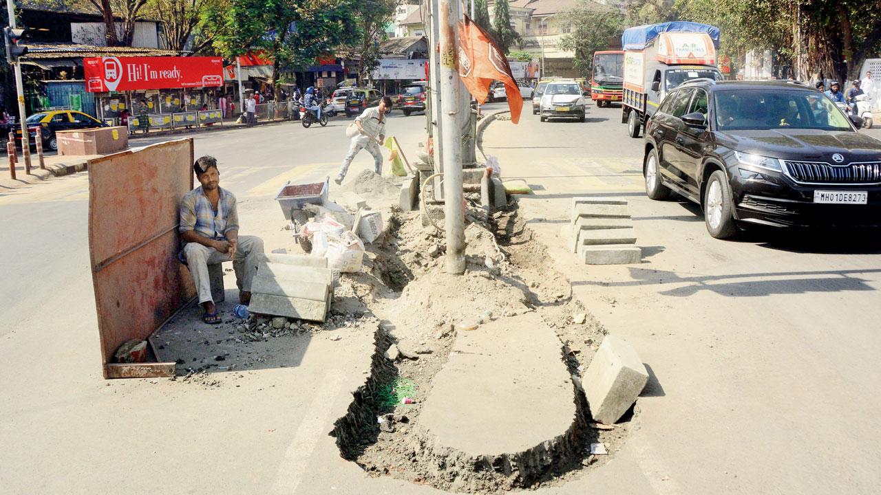 Work on to install tall dividers at Tardeo junction. Pic/Satej Shinde