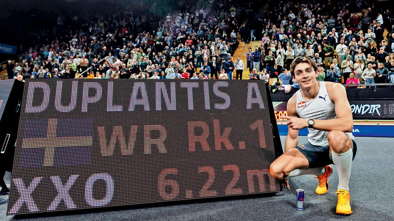 Duplantis is all smiles as he poses alongside his world record mark