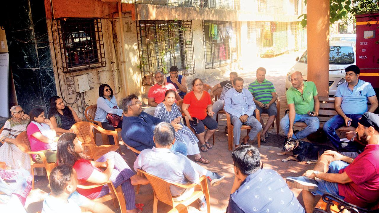 Residents of Royal Palms-I hold a meeting outside the building on Sunday