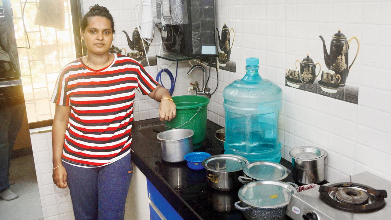 Rosalyn Nadar, a resident, shows the condition of her kitchen