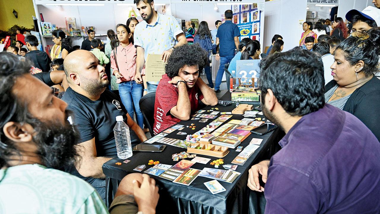 Participants lock horns over a game of Parks at an earlier convention
