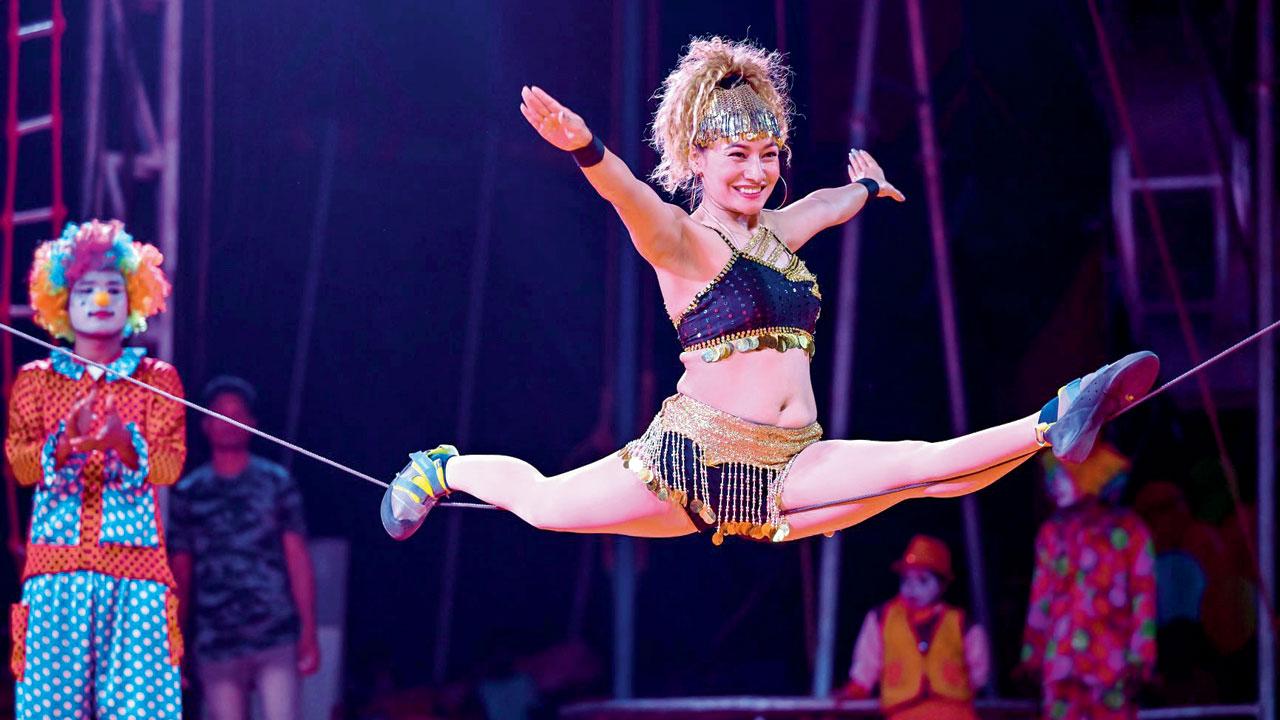 A performer balances on a rope