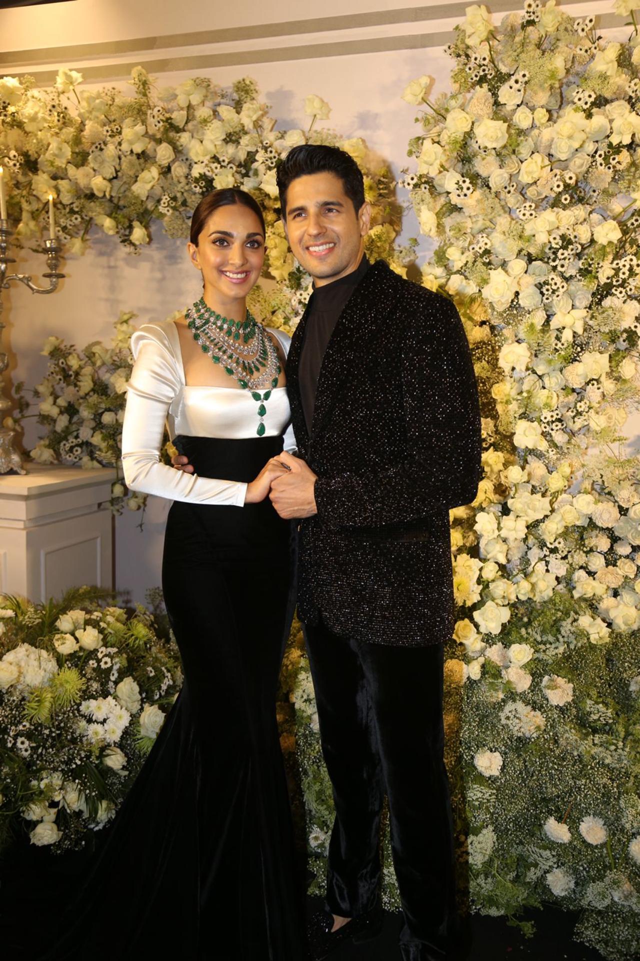 Sidharth and Kiara looked stunning as they posed together for the paparazzi. Kiara looked gorgeous in a white blouse and black body-hugging skirt. Highlight was her emerald neck piece. Sidharth looked dapper in a black suit
