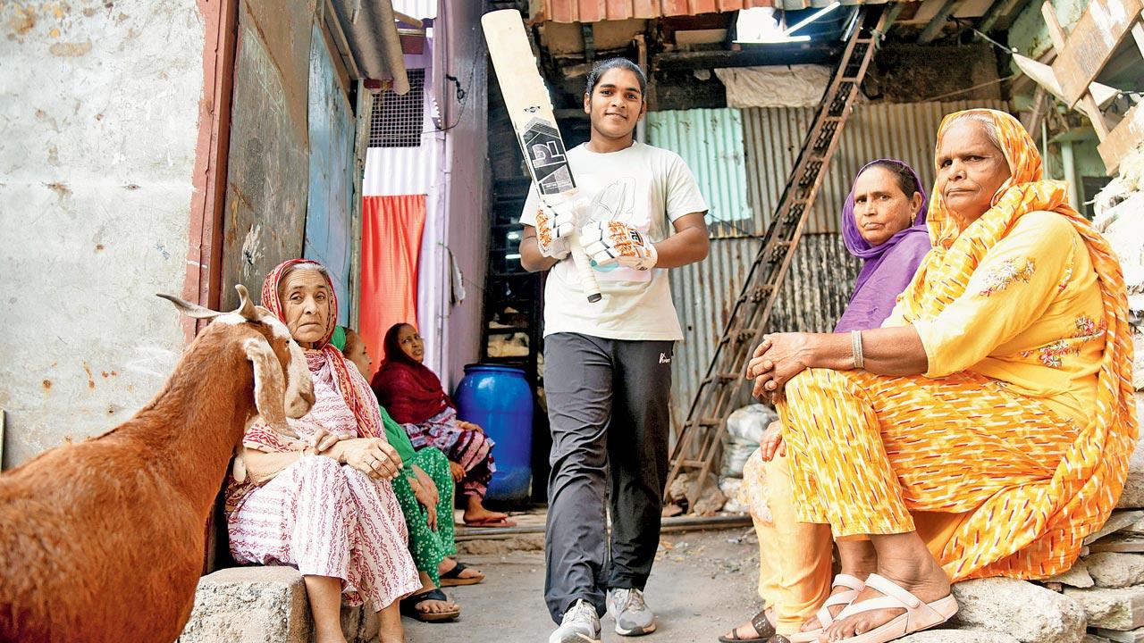 Simran Shaikh, who represented India ‘C’ at the Senior Women’s T20 Challenger Trophy in Raipur last November, gears up for a game of cricket, watched by her family in Dharavi’s Azad Nagar. The 21-year-old used to play gully cricket in the neighbourhood, before a relative encouraged her to play professionally. Pic/Sameer Markande