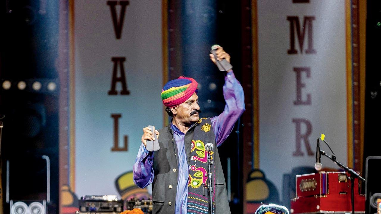 Barna performs with the khartal in his hands