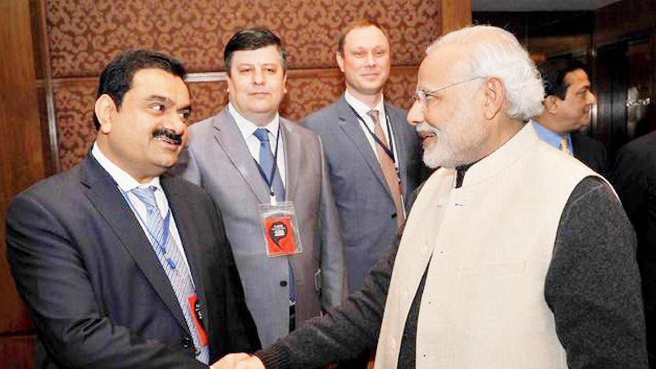 Gautam Adani and PM Narendra Modi. The corporate affairs ministry has briefed the PMO on the issue, govt officials told Reuters. File pic