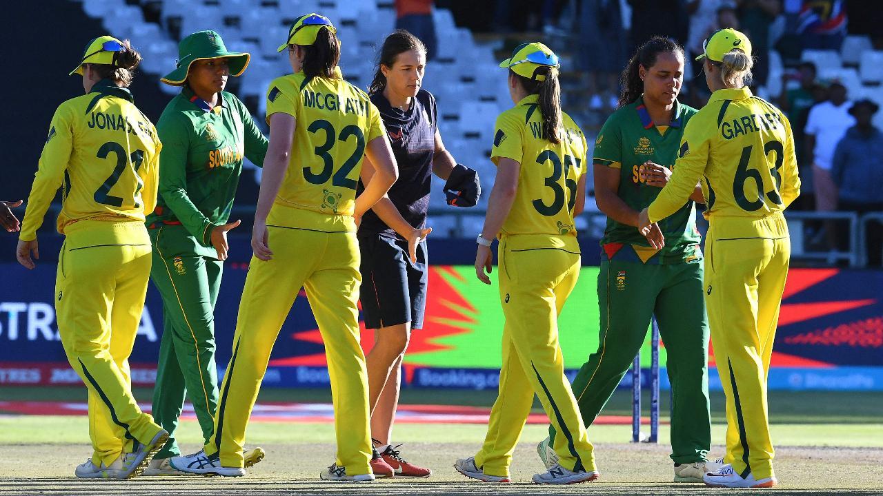 Australian players are congratulated after they won the final T20 women's World Cup cricket match between South Africa and Australia at Newlands Stadium in Cape Town on February 26, 2023.  (Pic Courtesy: AFP)