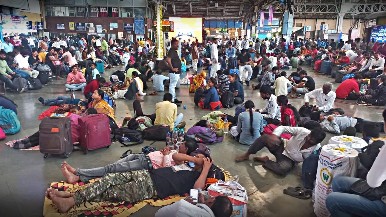 Passengers can be seen waiting at the Chhatrapati Shivaji Maharaj Terminus.