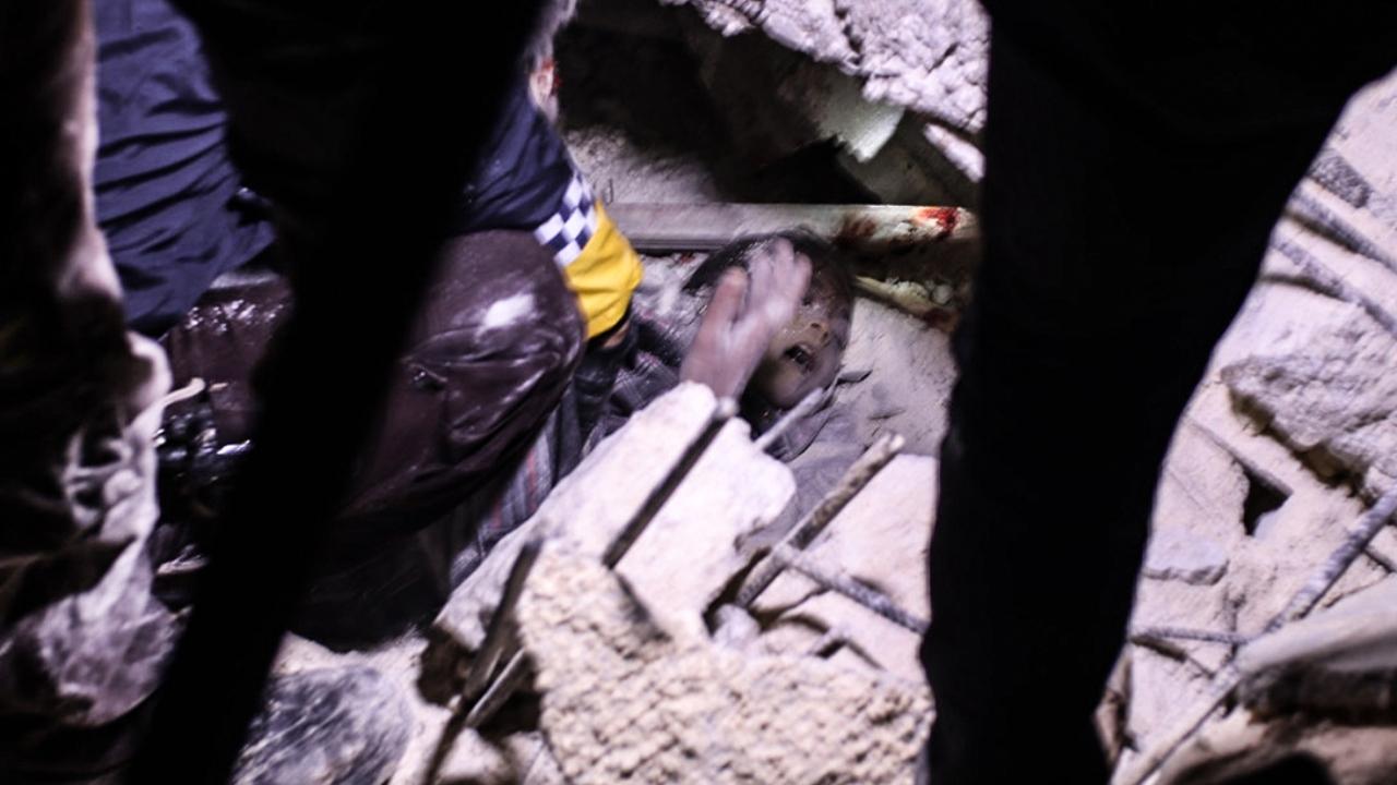 Rescuers try to free a young boy from the rubble of a collapsed building follwoing an earthquake, in the Syrian border town of Azaz in the rebel-held north of the Aleppo province. At least 42 have been reportedly killed in north Syria after an earthquake that originated in Turkey and was felt across neighbouring countries